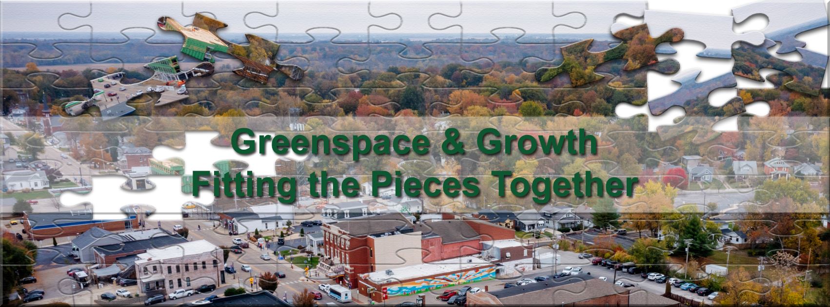 Drone photo of downtown Edwardsville with a puzzle piece overlap and the words Greenspace and Growth
